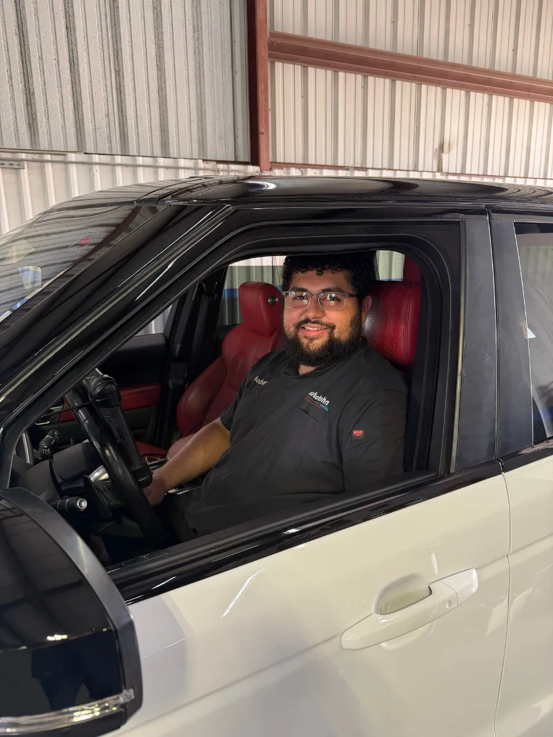 An excellent auto mechanic, Hector Sanchez, who focuses on European Cars Like Mercedes and BMW driving a car into the shop at Autobahn Werke